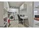 Functional laundry room providing storage cabinets and a convenient workspace with a built-in desk at 100 Spincast Ct, Peachtree City, GA 30269