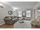 Inviting living room with hardwood floors and a comfortable olive green sofa at 100 Spincast Ct, Peachtree City, GA 30269