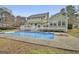 Backyard pool featuring a diving board, surrounded by a spacious deck and lush landscaping at 100 Spincast Ct, Peachtree City, GA 30269