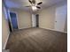 Carpeted bedroom featuring a ceiling fan, neutral walls and two doors leading to the other parts of the home at 3756 Bright Star Rd, Douglasville, GA 30135