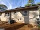 Side view of a brick home featuring multiple windows and an air conditioning unit at 3401 Longleaf Dr, Decatur, GA 30032