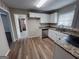 Kitchen featuring white cabinets, laminate floors, stainless steel dishwasher and granite countertops at 3401 Longleaf Dr, Decatur, GA 30032