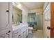 Cozy bathroom features a single sink vanity, patterned shower curtain, and tiled floors at 1387 John Robert Dr, Morrow, GA 30260