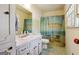 Bathroom with a white vanity and a shower with an ocean themed shower curtain at 1387 John Robert Dr, Morrow, GA 30260