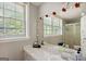 Bright bathroom featuring a single sink vanity, natural light, and an enclosed shower at 1387 John Robert Dr, Morrow, GA 30260