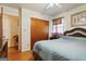 Comfortable bedroom features hardwood floors, a double door closet, and light blue bedding at 1387 John Robert Dr, Morrow, GA 30260