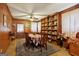 Elegant dining room with wood paneling, built-in shelving, and a spacious table at 1387 John Robert Dr, Morrow, GA 30260