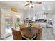 Sunlit kitchen featuring white cabinets, a breakfast area, and access to the backyard at 1387 John Robert Dr, Morrow, GA 30260