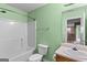 Full bathroom featuring a shower-tub combo, toilet, and vanity with decorative accents at 704 Davenport Ct, Stockbridge, GA 30281