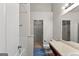 Well-lit bathroom featuring a shower/tub combo and closet with built-in shelving for ample storage solutions at 704 Davenport Ct, Stockbridge, GA 30281
