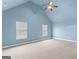 Large bedroom with a vaulted ceiling, fan, and two windows for ample natural light at 704 Davenport Ct, Stockbridge, GA 30281