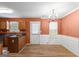 Cozy dining room with a decorative chandelier and wainscotting at 704 Davenport Ct, Stockbridge, GA 30281