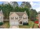 Traditional two-story home with a two-car garage, neutral siding, and landscaped front yard at 704 Davenport Ct, Stockbridge, GA 30281