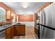 Modern kitchen with stainless steel appliances, granite countertops, and wooden cabinets at 704 Davenport Ct, Stockbridge, GA 30281