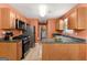 Efficient kitchen featuring stainless steel appliances, wood cabinets and sleek countertops at 704 Davenport Ct, Stockbridge, GA 30281
