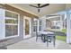 Covered patio area includes seating for four with brick architecture and views of the backyard at 5769 Tillman Way, Powder Springs, GA 30127