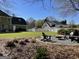 Backyard area with a fire pit, chairs, well maintained lawn and landscaping at 642 Grecken Grn, Peachtree City, GA 30269