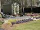 Backyard area with a fire pit, chairs, landscaping and a shed at 642 Grecken Grn, Peachtree City, GA 30269