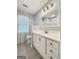 Bathroom featuring blue walls, tile floor, white vanity, and window at 642 Grecken Grn, Peachtree City, GA 30269