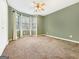 Bedroom featuring olive green walls, carpet, and a bank of windows at 642 Grecken Grn, Peachtree City, GA 30269