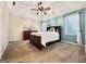 Comfortable bedroom featuring a tray ceiling with ceiling fan and natural light from a large window at 642 Grecken Grn, Peachtree City, GA 30269