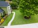 Aerial view of a home with mature trees, landscaping, and a walkway at 642 Grecken Grn, Peachtree City, GA 30269