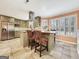 Eat-in kitchen boasts granite countertops, stainless steel appliances, and an island with seating at 642 Grecken Grn, Peachtree City, GA 30269