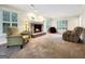 Inviting living room with a brick fireplace and large windows providing ample natural light at 642 Grecken Grn, Peachtree City, GA 30269