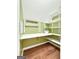 Functional pantry featuring a workspace with built-in shelving and wood-look flooring at 642 Grecken Grn, Peachtree City, GA 30269