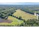 Aerial view of the large property featuring open land and dense trees at 4226 Highway 155 N, Stockbridge, GA 30281