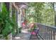 Back porch featuring red patio furniture and views of mature trees at 4226 Highway 155 N, Stockbridge, GA 30281