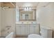 Traditional bathroom with a double sink vanity, large mirror, and bathtub with shower at 4226 Highway 155 N, Stockbridge, GA 30281