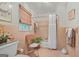 Bathroom tiled in pink with shower and tub combination at 4226 Highway 155 N, Stockbridge, GA 30281