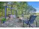 Cozy backyard firepit area with a swing, seating, and lush greenery, perfect for relaxing evenings outdoors at 4226 Highway 155 N, Stockbridge, GA 30281