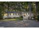 Charming single-story home with a stone chimney, wooden wheelchair ramp, and mature trees at 4226 Highway 155 N, Stockbridge, GA 30281