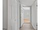 Bright hallway featuring hardwood floors, white walls, and multiple doorways leading to other rooms at 4226 Highway 155 N, Stockbridge, GA 30281