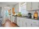 Bright kitchen featuring white cabinets, stainless steel appliances, and hardwood floors at 4226 Highway 155 N, Stockbridge, GA 30281