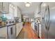 Bright kitchen featuring white cabinets, stainless steel appliances, and hardwood floors at 4226 Highway 155 N, Stockbridge, GA 30281