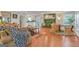 Open living room featuring hardwood floors, brick fireplace, and abundant natural light at 4226 Highway 155 N, Stockbridge, GA 30281