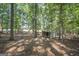 A metal shed sits among the trees on this shady property at 4226 Highway 155 N, Stockbridge, GA 30281