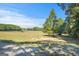 Vast grassy area on the property with trees and blue skies at 4226 Highway 155 N, Stockbridge, GA 30281