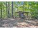 Rustic wood storage shed nestled among tall trees, providing a practical and charming outdoor feature at 4226 Highway 155 N, Stockbridge, GA 30281