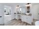 Bathroom with double sink vanity with granite counters and wood look tile flooring at 271 Trestle Rd, Locust Grove, GA 30248