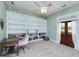 Bedroom features a built-in bookcase, a ceiling fan, and a door to the outdoors at 271 Trestle Rd, Locust Grove, GA 30248