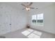 Bedroom has a ceiling fan, neutral paint, and large window at 271 Trestle Rd, Locust Grove, GA 30248