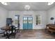 Elegant entryway with a vintage chandelier, wood floors, and inviting double doors that bring in lots of light at 271 Trestle Rd, Locust Grove, GA 30248