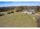Aerial view showcasing a charming home with a wide yard and a shed to the front at 271 Trestle Rd, Locust Grove, GA 30248