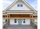 Detailed view of the charming front porch, complete with a covered ceiling and bright blue double doors at 271 Trestle Rd, Locust Grove, GA 30248