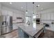 Modern kitchen with stainless steel appliances, stone countertops, and ample cabinet space at 271 Trestle Rd, Locust Grove, GA 30248