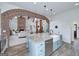 Open concept kitchen featuring a central island with stone countertops and open access to living room at 271 Trestle Rd, Locust Grove, GA 30248